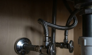 kinked braided supply hose under sink