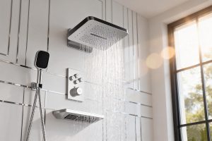 The image shows a modern shower system with a rainfall showerhead, handheld showerhead, control panel, and an additional shelf for storage