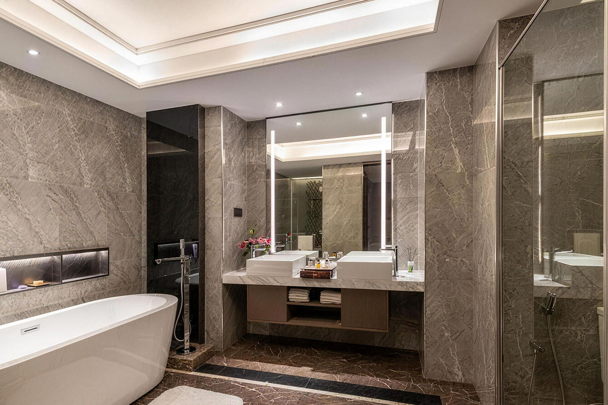 the image showcases an elegant bathroom with a gold faucet and showerhead, set against a luxurious backdrop of navy blue walls and marble countertops