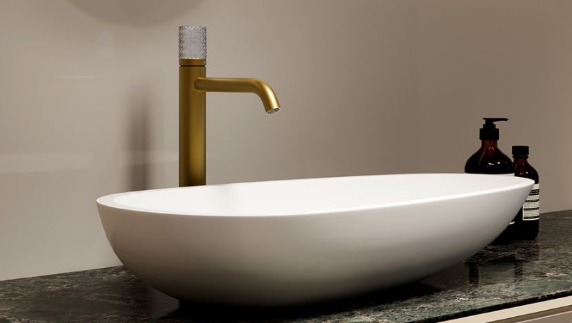 Champagne gold basin faucet with a brushed finish, paired with a white ceramic above-counter basin