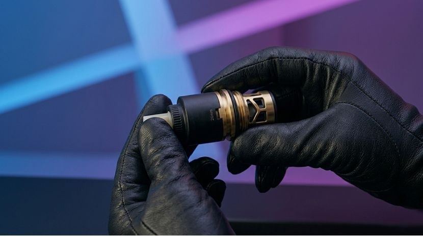 Close-up two hands holding a ceramic cartridge from a kitchen faucet